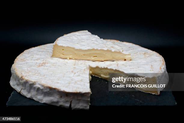 Picture shows a Brie de Meaux cheese displayed in a light box during a Wikicheese photo shoot, on May 15, 2015 in Paris. AFP PHOTO / FRANCOIS GUILLOT