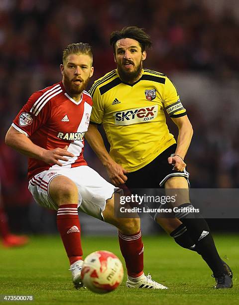 Jonathan Douglas of Brentford takes on Adam Clayton of Middlesbrough during the Sky Bet Championship Playoff semi final second leg match between...