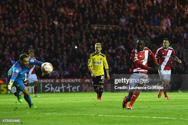 Albert Adomah of Middlesbrough shoots past goalkeeper David Button of Brentford to score their third goal during the Sky Bet Championship Playoff...