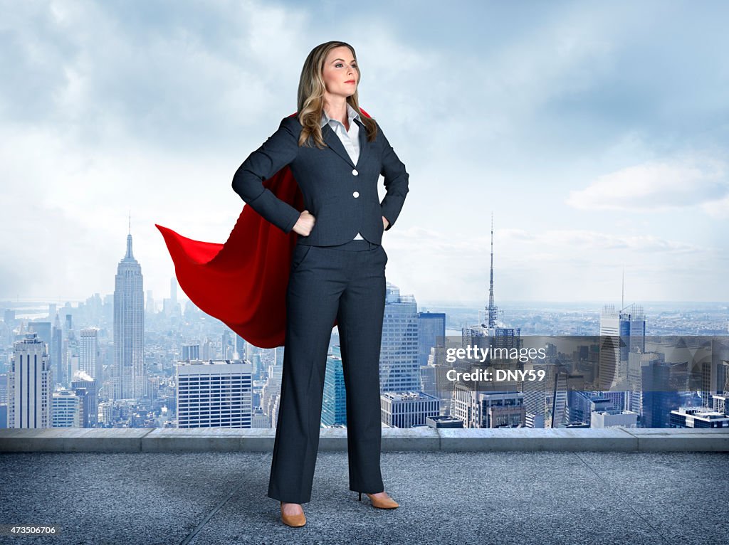 Superhero Businesswoman With Cityscape In The Background