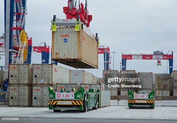Containers are loaded onto automated guided vehicles during the testing phase of the Long Beach Container Terminal in Middle Harbor at the Port of...