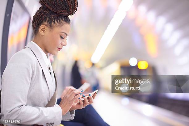 weibliche pendler in der u-bahn - businesswoman in suit jackets stock-fotos und bilder