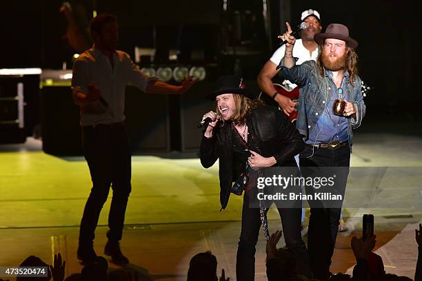 Singer Michael Hobby of the group A Thousand Horses joins Darius Rucker and John Osborne of The Brothers Osborne onstage at PNC Bank Arts Center on...
