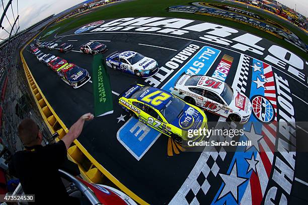 Greg Biffle, driver of the Ortho Ford, and Paul Menard, driver of the Serta/Menards Chevrolet, lead the field through the green flag to start the...
