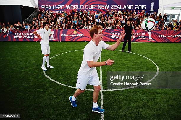 Prince Harry celebrates throws the ball in as he captains the New Zealand team playing the All Stars in a five a side game of football to promote...