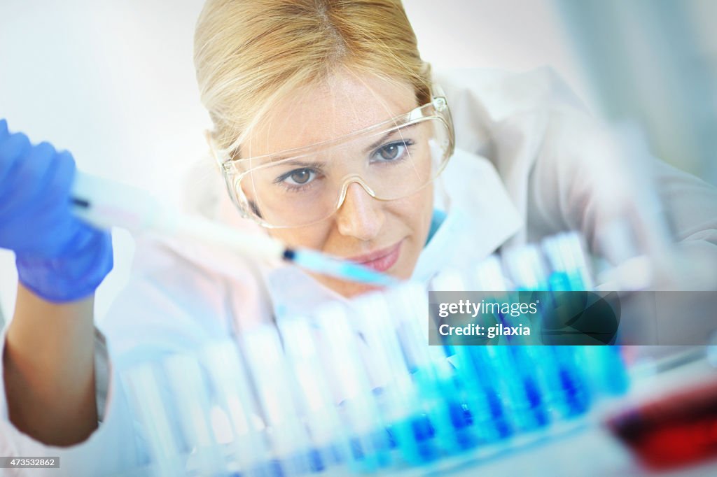 Female chemist at work in laboratory.