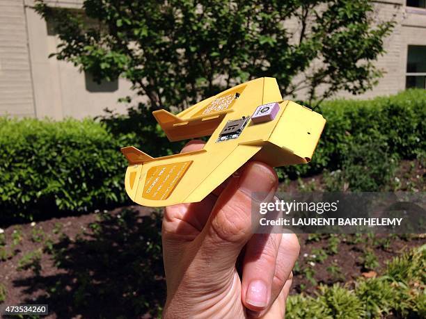 Man holds a Cicada, a miniature drone invented by US military scientists, outside the Pentagon in Washington, DC on May 14, 2015. The "Cicada", short...