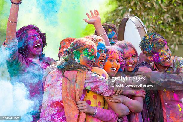 friends celebrating holi festival in india - ceremonial dancing stock pictures, royalty-free photos & images