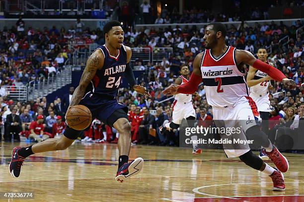 Kent Bazemore of the Atlanta Hawks drives against John Wall of the Washington Wizards during the second half at Verizon Center on May 15, 2015 in...