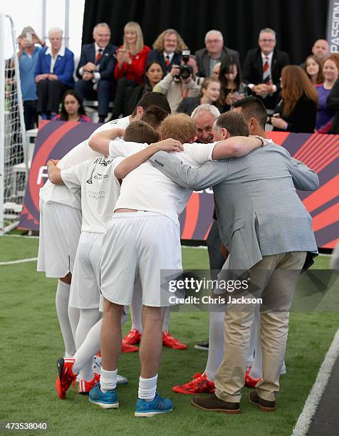 Prince Harry in a huddle with John Key as he captains the New Zealand team playing the All Stars in a five a side game of football to promote FIFA...