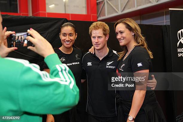 Prince Harry poses for a photo with New Zealand Netballers Maria Tutaia and Cathrine Latu visits the AUT Millenium Institute on May 16, 2015 in...