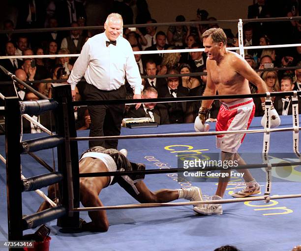 Mitt Romney, watches after he knocked down Evander Holyfield , during a fight in a charity boxing event on May 15, 2015 in Salt Lake City, Utah. The...