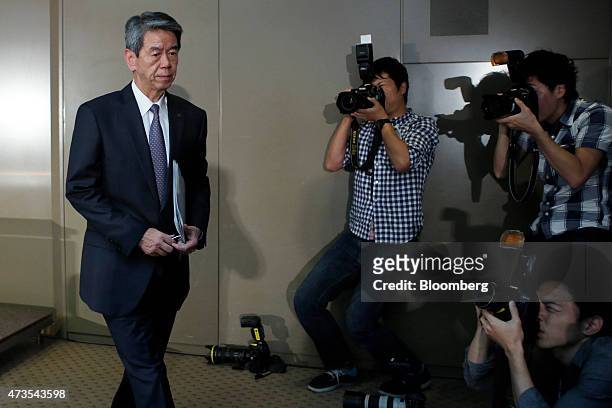 Hisao Tanaka, president and chief executive officer of Toshiba Corp., left, leaves a news conference at the company's headquarters in Tokyo, Japan,...