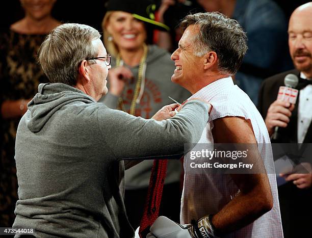 Mitt Romney has his tie cut off of him before a fight with Evander Holyfield in a charity boxing event on May 15, 2015 in Salt Lake City, Utah. The...