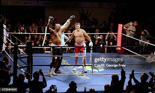 Evander Holyfield celebrates his win over Mitt Romney during a charity boxing event on May 15, 2015 in Salt Lake City, Utah. The event was held to...