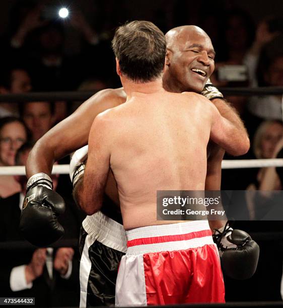 Mitt Romney, and Evander Holyfield , hug after a charity boxing event on May 15, 2015 in Salt Lake City, Utah.The event was held to raise money for...