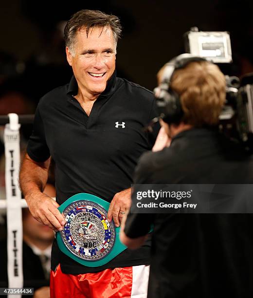 Mitt Romney shows off his boxing belt after a fight with Evander Holyfield during a charity boxing event on May 15, 2015 in Salt Lake City, Utah. The...