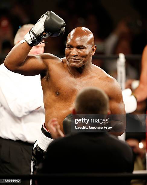 Evander Holyfield celebrates his win over Mitt Romney during a charity boxing event on May 15, 2015 in Salt Lake City, Utah. The event was held to...