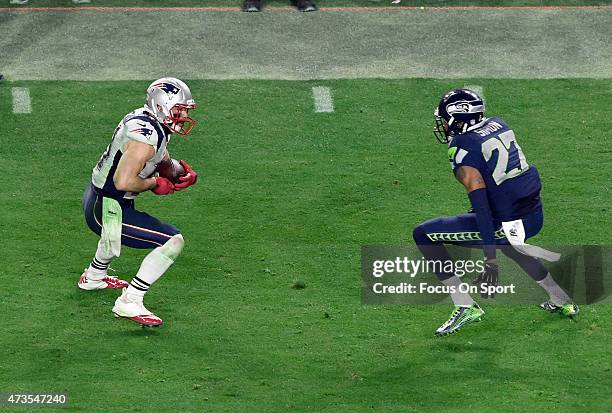 Julian Edelman of the New England Patriots looks to put a move on Tharold Simon of the Seattle Seahawks in Super Bowl XLIX February 1, 2015 at the...