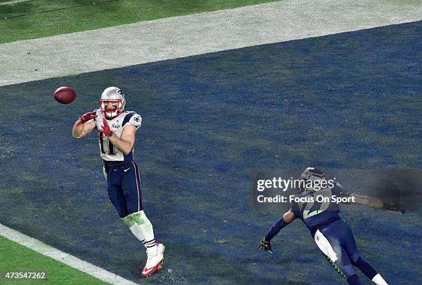 Julian Edelman of the New England Patriots catches a touchdown pass over Tharold Simon of the Seattle Seahawks in Super Bowl XLIX February 1, 2015 at...