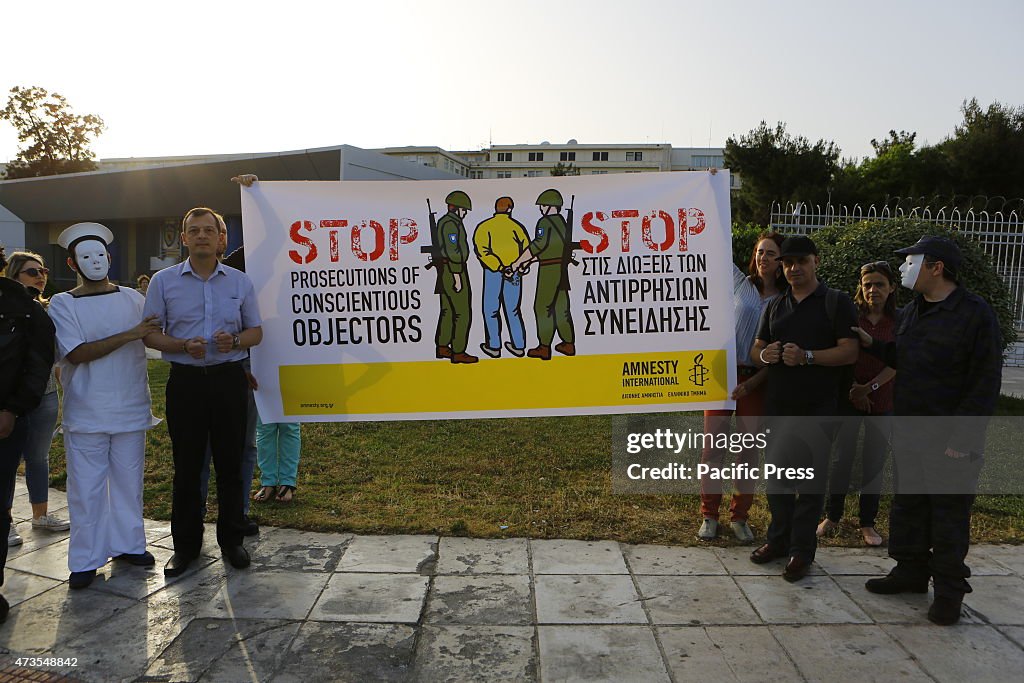 Protesters stand outside the Ministry of Defense, calling...