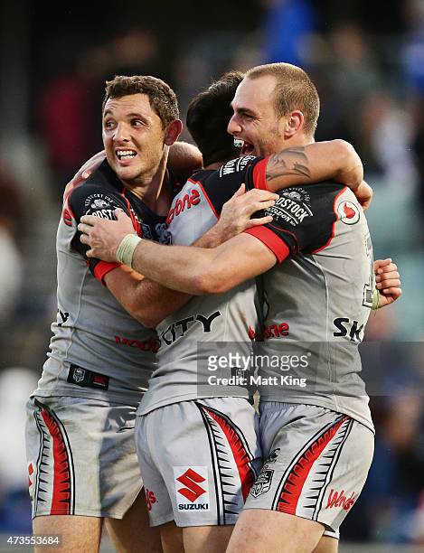 Jonathan Wright, Shaun Johnson and Simon Mannering of the Warriors celebrate the winning try in golden point extra time to Bodene Thompson of the...