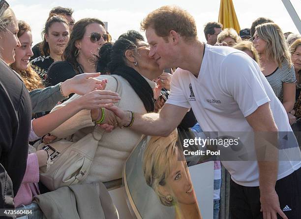 Prince Harry is kissed on the cheek by Faasiu Gaee from Samoa as he meets members of the public at an event to promote the 2015 FIFA U-20 World Cup...