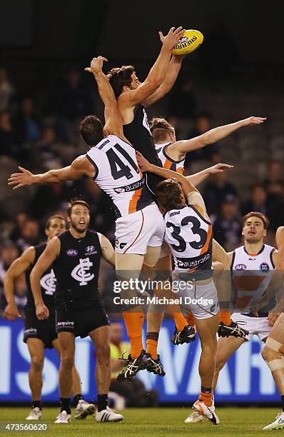 Levi Casboult of the Blues marks the ball against Shane Mumford of the Giants during the round seven AFL match between the Carlton Blues and the...