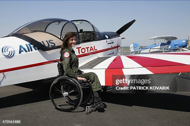 Disabled aerial acrobat Dorine Bourneton poses during an air show at the airfield of Saint-Cyr l'Ecole on April 19, 2015. AFP PHOTO / PATRICK KOVARIK