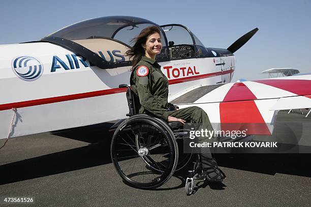 Disabled aerial acrobat Dorine Bourneton poses during an air show at the airfield of Saint-Cyr l'Ecole on April 19, 2015. AFP PHOTO / PATRICK KOVARIK