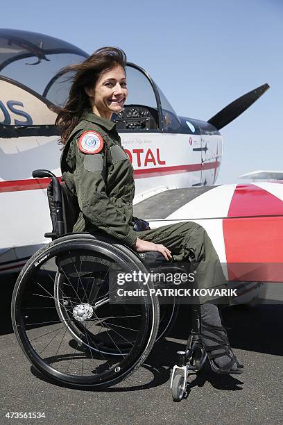 Disabled aerial acrobat Dorine Bourneton poses during an air show at the airfield of Saint-Cyr l'Ecole on April 19, 2015. AFP PHOTO / PATRICK KOVARIK