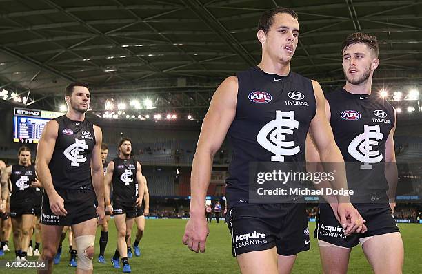 Ed Curnow of the Blues and Marc Murphy of the Blues leads the team off after defeat during the round seven AFL match between the Carlton Blues and...