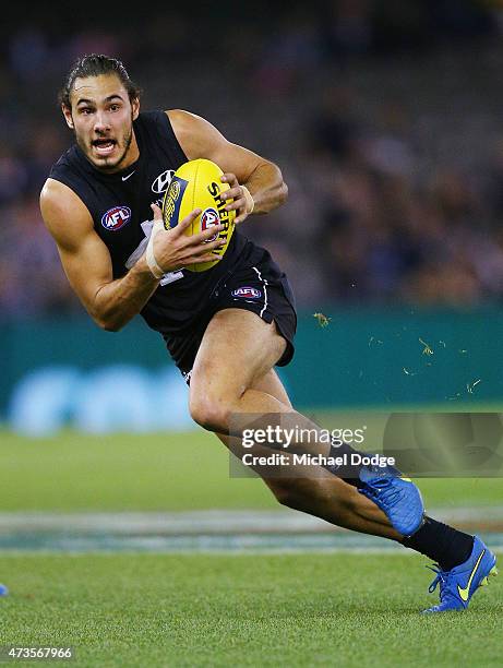 Troy Menzel of the Blues runs with the ball during the round seven AFL match between the Carlton Blues and the Greater Western Sydney Giants at...