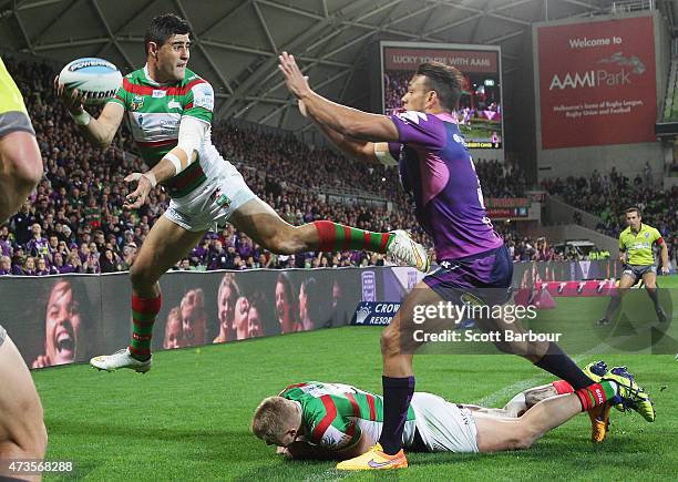 Bryson Goodwin of the Rabbitohs attempts to pass the ball back as he leaps over the dead ball line during the round 10 NRL match between the...