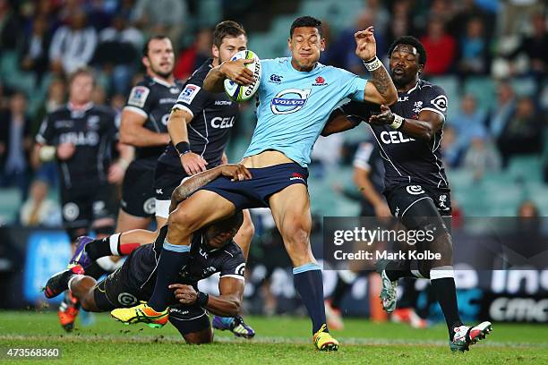 Israel Folau of the Waratahs is tackled during the round 14 Super Rugby match between the Waratahs and the Sharks at Allianz Stadium on May 16, 2015...