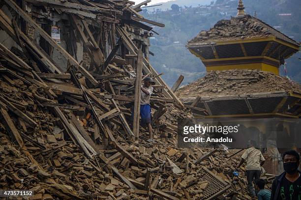 Locals search for their valuable goods among collapsed houses in Sankhu village in, Kathmandu, Nepal on May 16, 2015 following the second major...