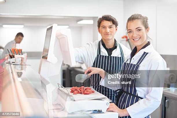 young apprentice butchers - slagerij stockfoto's en -beelden