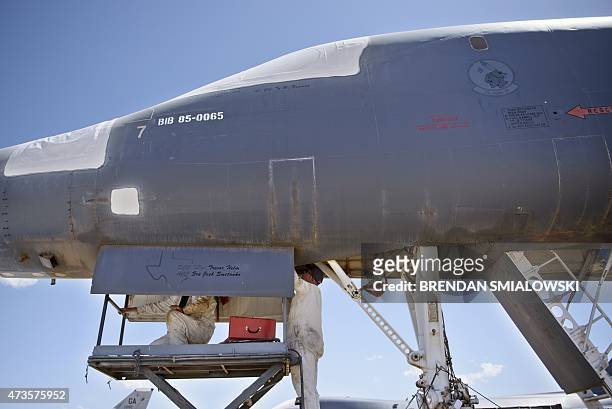 Aerospace Maintenance and Regeneration Group employees remove a part from a A Rockwell B-1 Lancer bomber stored in the boneyard on Davis-Monthan Air...