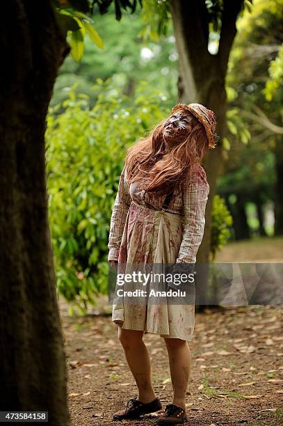 Participants take part in a 'zombie walk' at a park in Tokyo on May 16, 2015. More than 100 zombie fans lurched around a city park for an annual...