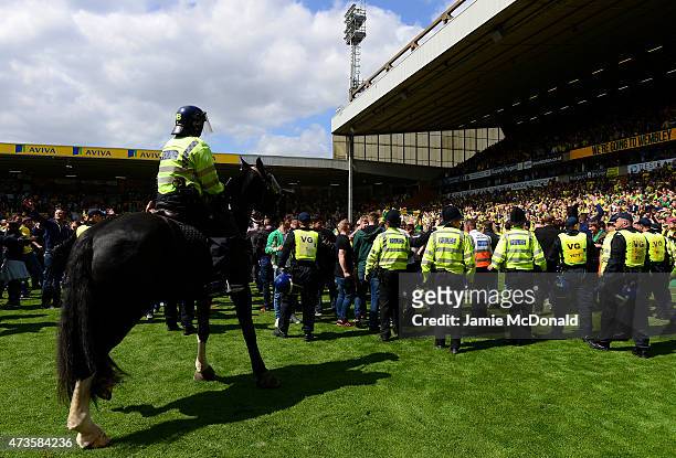 Stewards and police control fans after a pitch invasion during the Sky Bet Championship Playoff semi final second leg match between Norwich City and...