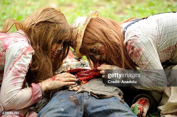 Participants take part in a 'zombie walk' at a park in Tokyo on May 16, 2015. More than 100 zombie fans lurched around a city park for an annual...