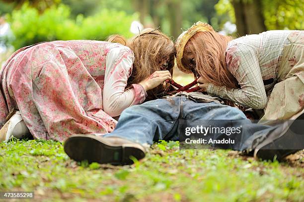 Participants take part in a 'zombie walk' at a park in Tokyo on May 16, 2015. More than 100 zombie fans lurched around a city park for an annual...