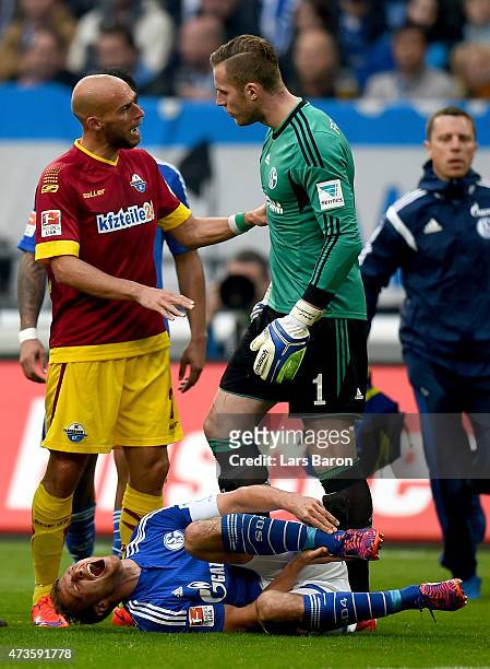 Benedikt Howedes of Schalke 04 lies injured on the pitch after a tackle of Daniel Bruckner of SC Paderborn during the Bundesliga match between FC...