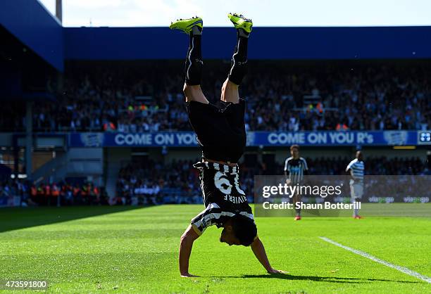 Emmanuel Riviere of Newcastle United celebrates scoring the opening goal during the Barclays Premier League match between Queens Park Rangers and...