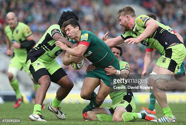 Ben Youngs of Leicester is tackled by Ahsee Tuala , Lee Dickson ; James Craig during the Aviva Premiership match between Leicester Tigers and...