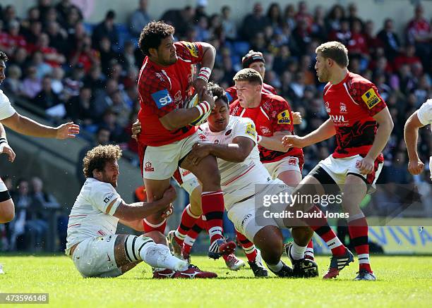 Opeti Fonua of London Welsh is tackled by Petrus Du Plessis and Billy Vunipola of Saracens during the Aviva Premiership match between London Welsh...