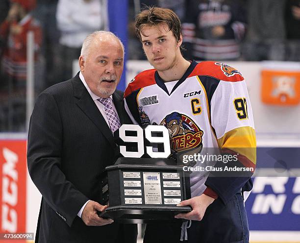 Canadian Hockey League Commisioner David Branch presents Connor McDavid of the Erie Otters with the Wayne Gretzky 99 trophy as playoff MVP after...