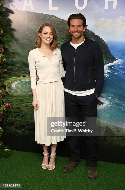 Emma Stone and Bradley Cooper attend a photocall for 'Aloha' at Soho Hotel on May 16, 2015 in London, England.