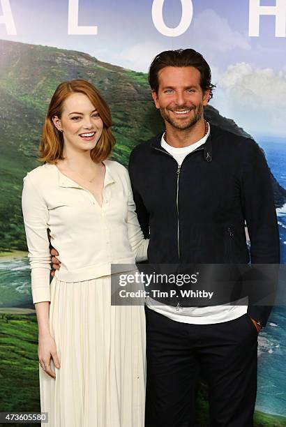 Emma Stone and Bradley Cooper attend a photocall for 'Aloha' at Soho Hotel on May 16, 2015 in London, England.