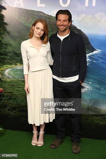 Emma Stone and Bradley Cooper attend a photocall for 'Aloha' at Soho Hotel on May 16, 2015 in London, England.